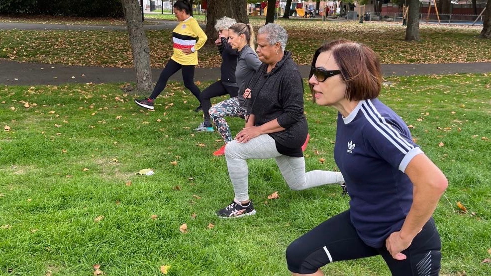 A group of women participating in a community park circuit training session in Plaistow